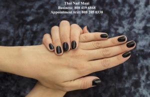 Beautiful woman's nails with beautiful french manicure handsome black with glitter